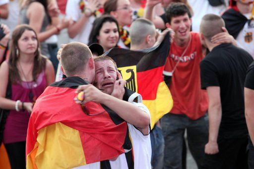 Soccer fans celebrate the 2-2 equaliser goal of Germany at the public viewing area of the fan fest on the Heiligengeistfeld in Hamburg Germany 10 July 2010. The German team plays against Uruguay for the third place of the FIFA World Cup 2010 in ...