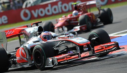 British driver Jenson Button of Mc Laren Mercedes steers his car ahead of Spanish driver Fernando Alonso of Ferrari during the 2010 Formula One Italian Grand Prix at the Autodromo Nazionale in Monza Italy 12 September 2010. Photo: Peter