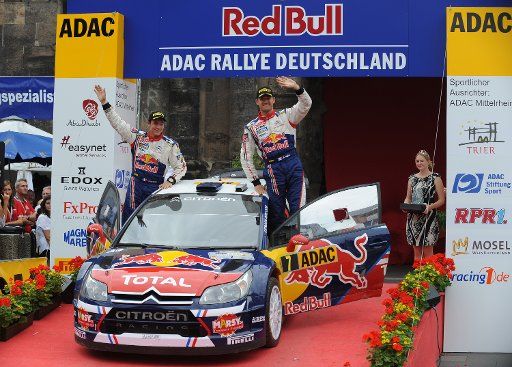 French driver Sebastien Ogier (R) of Citroen and his co-pilot Julien Ingrassia celebrate their third place at the WRC Rally Germany in Trier Germany 22 August 2010. Photo: Harald