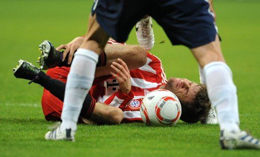 Thomas Mueller of FC Bayern Munich lies and the ground and holds his leg in pain at Allianz Arena in Munich Germany 29 October 2010. Photo: Tobias