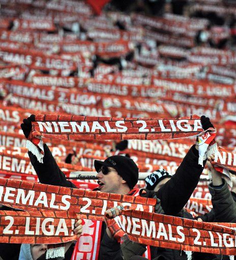 Supporters of VfB Stuttgart present scarfs reading \