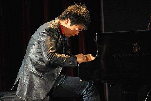 Star pianist Lang Lang from China plays the piano at the festival hall in Baden-Baden Germany 15 April 2011. At his performance in front of 80 high school students from the region the 28-year-old tried to bring piano music closer to the children. ...
