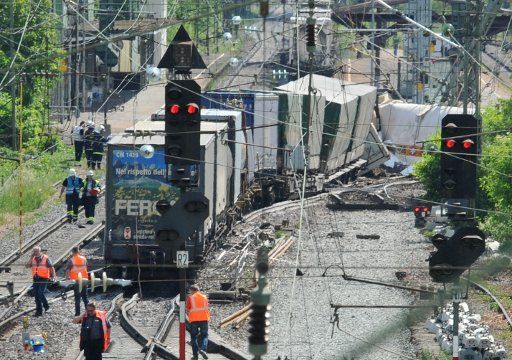 A firemen secure the site of a derailed railway car in Muellheim Germany 20 May 2011. The Karlsruhe-Basel rail line has been completely blocked after at least eight cars of a freight train some of which were carrying hazardous material derailed ...