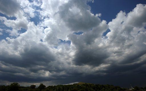 Dark clouds move acorss a field in Speyer Germany 19 May 2011. Photo: Ronald