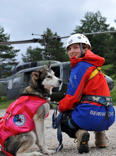 Dog handler Mona of the mountain rescue service Bavaria and her dog Hunter wait for their practice operation in the mountains in Mittenwald germany 17 June 2011. The avalanche search dogs team of the mountain rescue service Bavaria practise flying ...