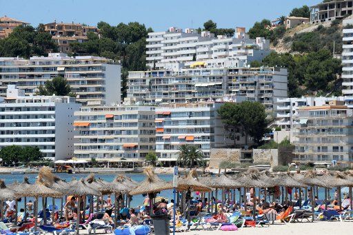 The hotel buildings with tourists on the beach are pictured in Costa De La Calma Spain 21 June 2011. The region is a tourist destination popular especially among German travellers. The peak of the season is close. Photo: Patrick