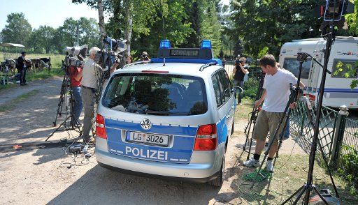 ( CORRECTION - DATE ) A police car passes journalists in front of the market gardening company Bienenbuettel in Neu-Steddorf Germany 06 June 2011. Sprouts from Bienbuettel could be the source of the EHEC infection. Photo: PHILIPP