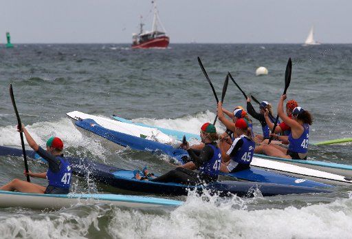 Participants of the discipline Ski Race take part in the 15th International DLRG Cup for life-guards at the Baltic Sea in Warnemuende Germany 15 July 2011. 350 life-guards from 9 nations compete on water and land until 16 July 2011. Photo: Bernd ...