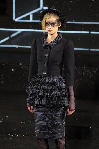A model presents a creation by Karl Lagerfeld for Chanel from the Fall\/Winter 2011\/2012 Haute Couture collection presented during the Paris Fashion Week in Paris France 5 July 2011. The presentation of the Fall\/Winter 2011\/2012 collections takes ...