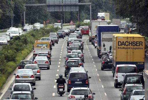 Cars and trucks jam at the Autobahn A3 in Leverkusen Germany 29 July 2011. Due to the end of classes in Bavaria traffic jams occur on several motorways. Jams are expected especially at the weekend. Photo: OLIVER
