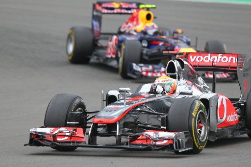 British Formula One driver Lewis Hamilton of McLaren Mercedes leads in front of Australian Formula One driver Mark Webber of Red Bull during the Formula One Grand Prix of Germany at the F1 race track of Nuerburgring Nuerburg Germany 24 July 2011. ...