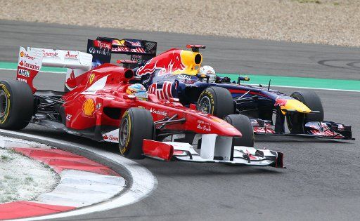 Spanish Formula One driver Fernando Alonso (L) of Ferrari leads the pack in front of German Formula One driver Sebastian Vettel of Red Bull during the Formula One Grand Prix of Germany at the F1 race track of Nuerburgring Nuerburg Germany 24 July ...