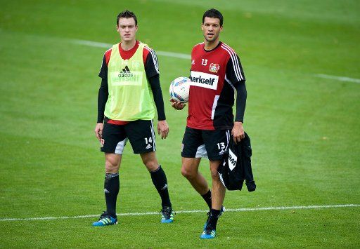 Michael Ballack (R) from Bayer Leverkusen speaks to his teammate Hanno Balitsch during the training session at the training grounds of the BayArena in Leverkusen Germany 30 August 2011. During the Bundesliga match against Borussia Dortmund on 27 ...