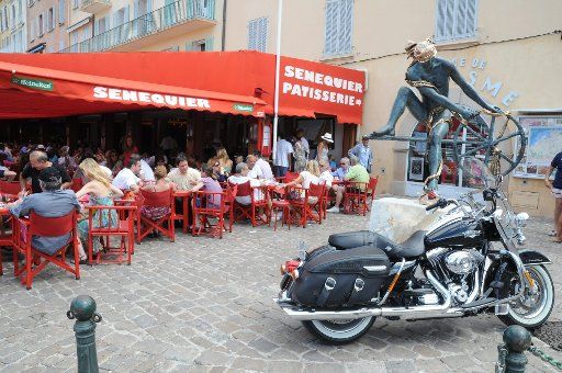 Guests crowd at Cafe Senequier at the harbour of Saint-Tropez at the Cote d\