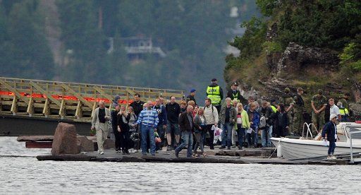 Relatives of the victims that died in the shooting stand at the docks to cross over to the island of Utoya Norway 19 August 2011. Four weeks later Oslo remembers the deadly attack from 22 July in which 77 people died. Eight of them were killed by ...