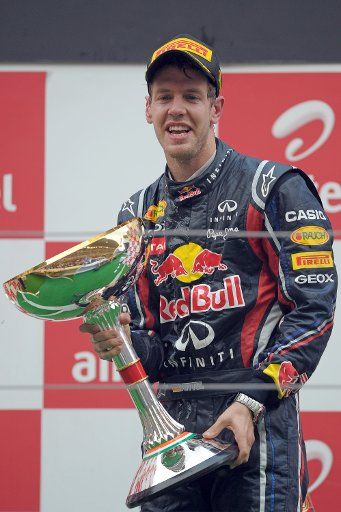 German Formula One driver Sebastian Vettel of Red Bull celebrates with his trophy on the podium at the race track Buddh International Circuit Greater Noida India 30 October 2011. Vettel won the first-ever Formula One Grand Prix of India. Photo: ...