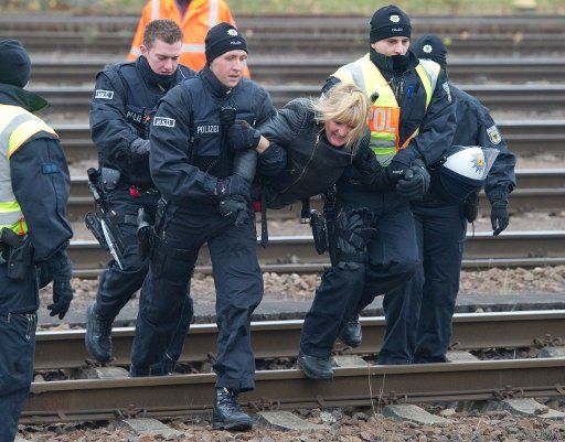 A protester is carried off by police shortly before the train carrying the 11 CASTOR containers arrives in Neunkirchen Germany 25 November 2011. The 13th CASTOR transport containing German nuclear has reached Germany and is expected to arrive in ...
