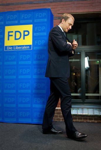 Politician Christian Lindner leaves the stage after a press statement on his resignation as FDP secretary-general in Berlin Germany 14 December 2011. Before making the announcement Lindner had informed FDP party leader Roesler in a personal ...