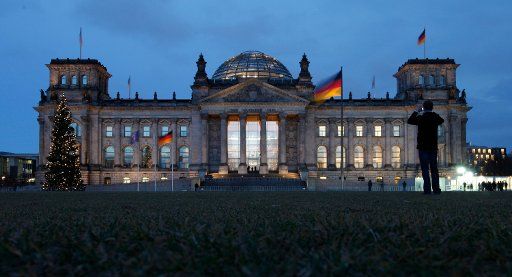A man takes a photo of the Reichstag in Berlin Germany 05 December 2011. Photo: Florian