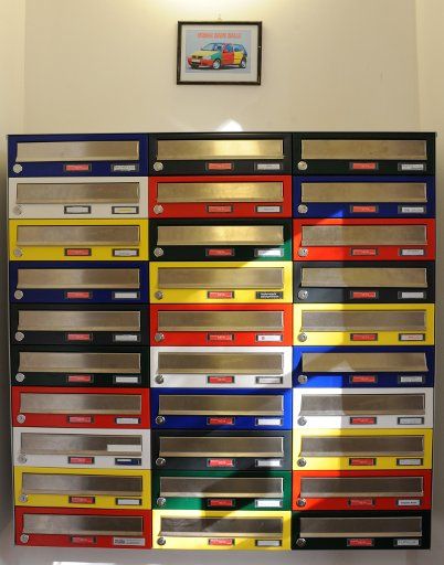 Colourful mailboxes are set up inside the entrance hall of the designer house in Halle\/Saale Germany 03 November 2011. Photo: Waltraud