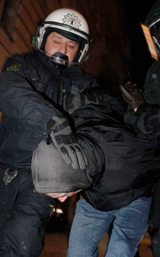 A police officer takes a demonstrator into custody during a demonstration against the European Police Congress in Berlin, Germany, 28 January 2012. Several hundred people attended the demonstration under the motto \