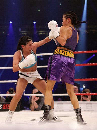 WIBA flyweight World Champion Nadia Raoui (L) fights challenger US American Eileen Olszewski the Lanxess Arena in Cologne, Germany, 13 April 2012. Sturm defended his title with a technical knockout. Photo: Rolf