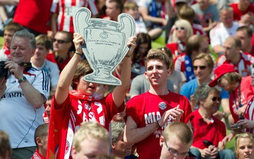 Fans celebrate prior to the Ultimate Champions Match between players of FC Bayern All-Stars & Friends and World All-Stars at the Olympic stadium in Munich, Germany, 19 May 2012. A group of former famous soccer players came together to take part in ...