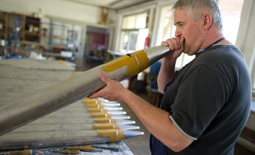 An employee of organ pipe manufacturer Mittermaier & Soehne tries out an organ pipe Sinsheim, Germany, 24 May 2012. Photo: Uwe