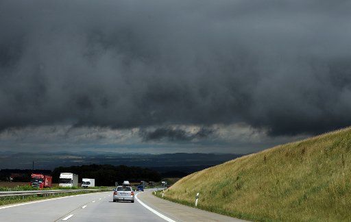 Almost black Rain clouds hang menacingly over the A17 in Pirna, Germany, 17 July 2012. Photo: MATTHIAS 