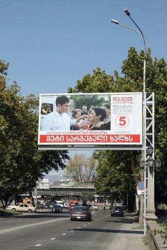 A campaign poster of the Saakashvili party is put up in Tbilisi, Georgia, 17 September 2012. Photo: ULF Ulf