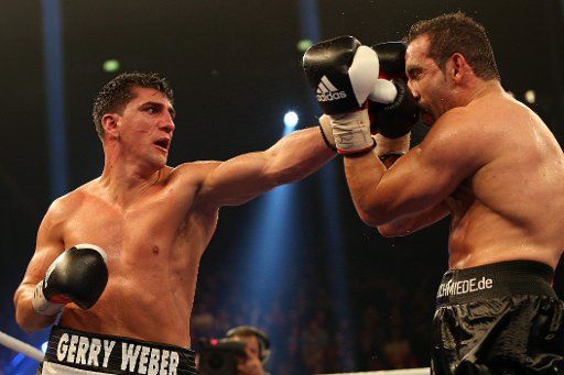 German WBO cruiserweight champion Marco Huck (L) fights against his German challenger Firat Arslan at Gerry Weber Stadium in Halle, Germany, 03 November 2012. Photo: Kevin