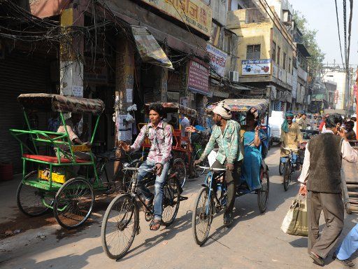 Bike rickshaws drive through the streets of Old Delhi in India, 23 November 2012. Photo: Jens