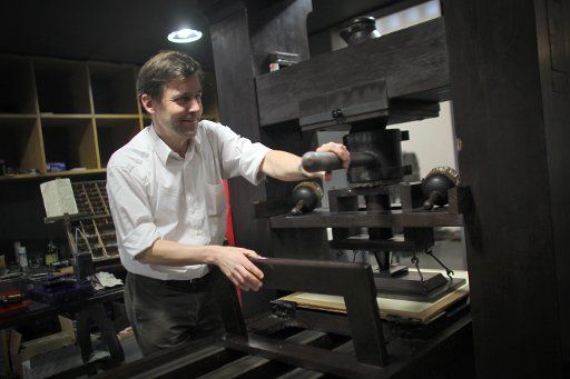 Swiss author Peter Stamm poses with a printing press at the Gutenberg Museum in Mainz, Germany, 22 February 2013. Stamm is awarded the 2013 Mainz Writer in Residence Prize, which is endowed with 12,500 euros. Photo: FREDRIK VON