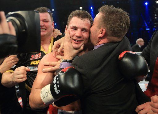 German Robert Stieglitz celebrates with his trainers after defeating Armenian-German Arthur Abraham in their WBO supermiddleweight title bout in Magdeburg, Germany, late 23 March 2013. Stieglitz won with a technical k.o. in fourth round. Photo: Jens ...