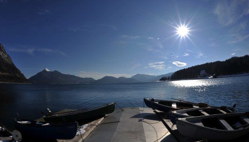 Rowing boats are visible at a jetty of the Walchensee (lake) on a clear and sunny day in Walchensee, Germany, 17 March 2013. Photo: Frank