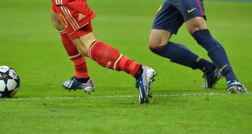 Legs of soccer players are pictured during the first leg of the UEFA Champions League semifinal between Bayern Munich and FC Barcelona at Allianz Arena in Munich, Germany, 23 April 2013. Photo: Peter