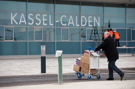 A man transports boxes on a trolly at Kassel Calden Airport in Calden, Germany, 03 April 2013. After one and a half years of planning, testing and building the new Kassel Calden Airport will open on 04 April 2013. Photo: UWE