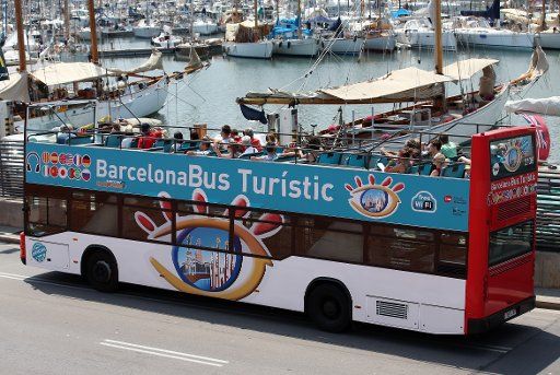 A touristic bus is seen at Moll de la Fusta (Port Vell) during the 15th FINA Swimming World Championships in Barcelona, Spain, 21 July 2013. Photo: Friso Gentsch\/