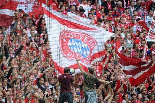 Fans of Bayern wave flags during to the Bundesliga soccer match at Allianz Arena in Munich, Germany, 14 September 2013. Bayern wins 2-0. Photo: TOBIAS HASE\/