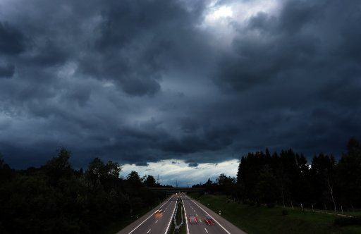 11 August 2019, Bavaria, Oy-Mittelberg: Thunderstorm clouds are moving over the A7 motorway. Photo: Karl-Josef Hildenbrand\/