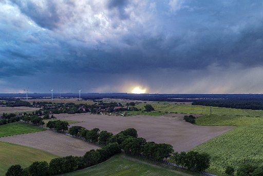 18 August 2019, Brandenburg, Sieversdorf: Dark clouds of rain move over the landscape in the Oder-Spree district (aerial photograph with a drone). Photo: Patrick Pleul\/dpa-Zentralbild\/