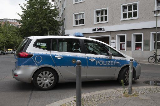 22 July 2019, Berlin: A patrol car stands in front of the Karl Liebknecht House, the party headquarters of the left. The building was evacuated because of a threatening letter. A spokeswoman for the party spoke of a bomb threat that had been received by email. Photo: Paul Zinken\/