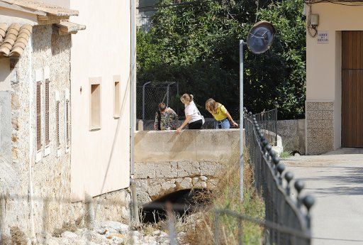 11 September 2019, Spain, Caimari: Neighbors look at the Caimari torrent in Mallorca after heavy rainfall in some parts of the island recorded yesterday. In 19 municipalities the schools have closed to prevent even though the sun has risen today. Photo: Clara Margais\/