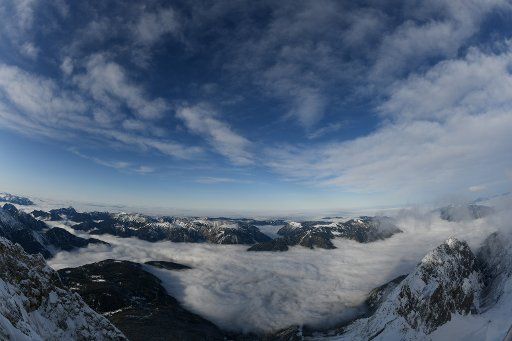 16 November 2019, Bavaria, Grainau: The peaks of the foothills of the Alps rise from the clouds. Photo: Angelika Warmuth\/