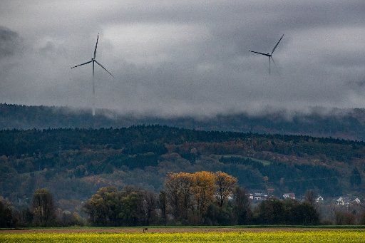 05 November 2019, Bavaria, Wiesenfelden: Wind turbines rise out of the fog. Photo: Armin Weigel\/