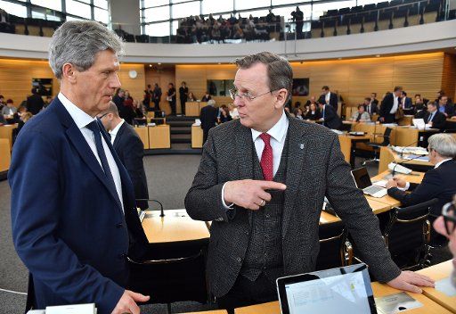 29 January 2020, Thuringia, Erfurt: Bodo Ramelow (r., Die Linke), Minister President of Thuringia, and Helmut Holter (l., Die Linke), Minister for Education, Youth and Sport of Thuringia, speak to each other before the start of the state parliament session in Thuringia. . Photo: Martin Schutt\/dpa-Zentralbild\/