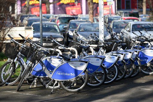 15 January 2020, Hessen, Kassel: Rental bikes of the bike rental Nextbike are located next to the campus of the University of Kassel in front of a car park. Photo: Uwe Zucchi\/