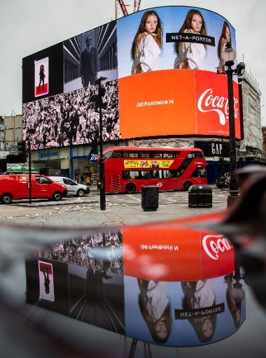 19 February 2020, Great Britain, London: A double-decker scheduled bus runs over Piccadilly Circus, a world famous crossroads and public square in London\