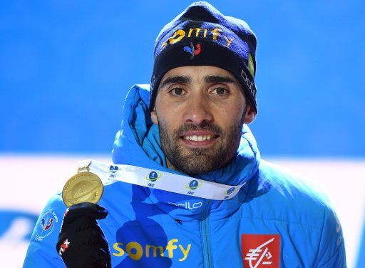 19 February 2020, Italy, Antholz: Biathlon: World Championship, Individual 20 km, Men. Martin Fourcade from France shows his gold medal during the Medals Ceremony. Photo: Hendrik Schmidt\/