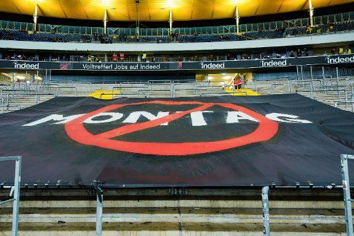 24 February 2020, Hessen, Frankfurt\/Main: Football: Bundesliga, 23rd matchday, Eintracht Frankfurt - 1 FC Union Berlin, in the Commerzbank Arena. A banner with the crossed out writing "Monday" is stretched out in the Frankfurt fan block. Photo: Uwe Anspach\/dpa - IMPORTANT NOTE: In accordance with the regulations of the DFL Deutsche Fußball Liga and the DFB Deutscher Fußball-Bund, it is prohibited to exploit or have exploited in the stadium and\/or from the game taken photographs in the form of sequence images and\/or video-like photo series.
